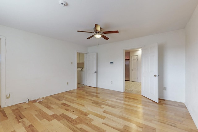 unfurnished bedroom with washer / dryer, light wood-type flooring, and ceiling fan