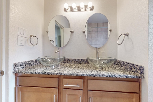 bathroom featuring double vanity and a sink