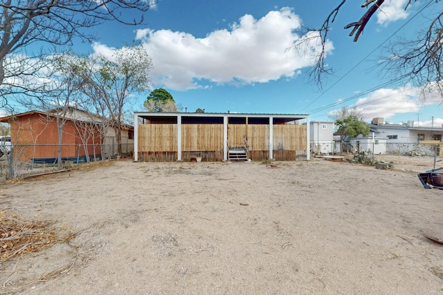 view of yard with an outbuilding and fence