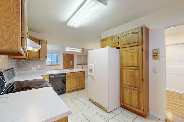 kitchen with light countertops, black dishwasher, stainless steel electric range, white refrigerator with ice dispenser, and a sink