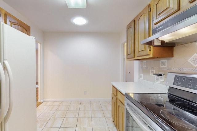 kitchen featuring electric range, freestanding refrigerator, decorative backsplash, light countertops, and under cabinet range hood