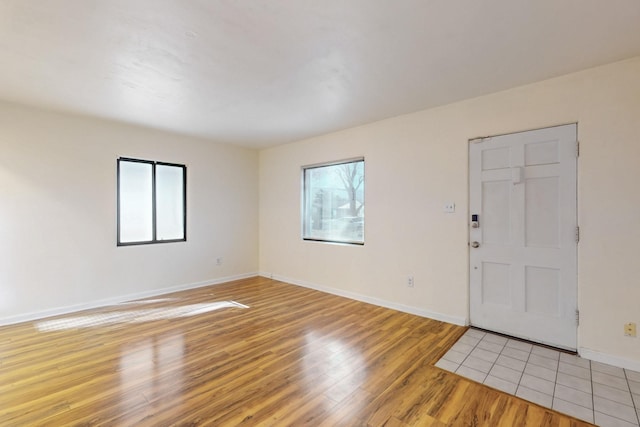 entrance foyer with light wood-style flooring and baseboards