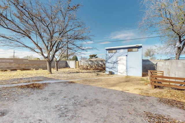 view of yard featuring an outbuilding, a shed, and a fenced backyard