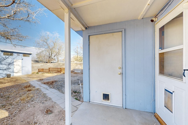 view of exterior entry with fence