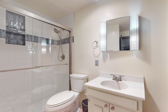 full bath featuring a stall shower, toilet, and vanity