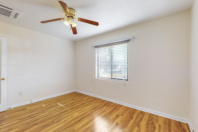 unfurnished room featuring baseboards, visible vents, a ceiling fan, and light wood-style floors