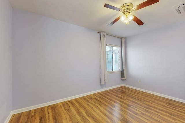 empty room with visible vents, baseboards, light wood-style floors, and a ceiling fan