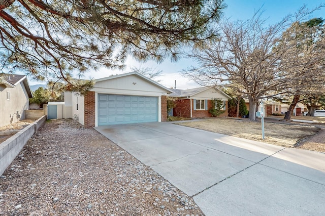 ranch-style house featuring brick siding, an attached garage, and concrete driveway