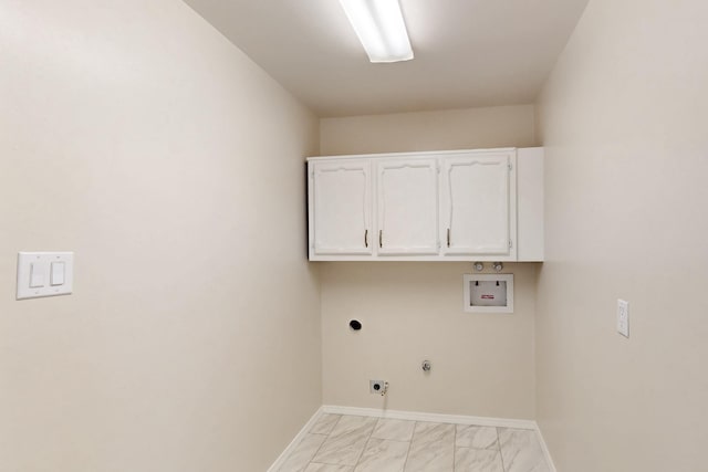 washroom featuring hookup for a washing machine, cabinet space, marble finish floor, and baseboards