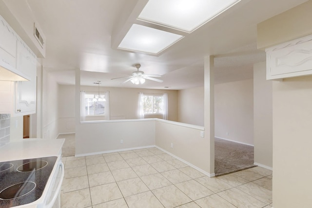 kitchen with a ceiling fan, visible vents, baseboards, light countertops, and white cabinetry