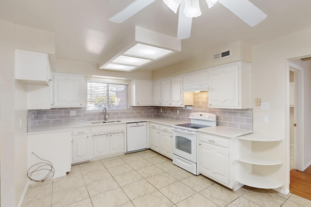 kitchen with white cabinets, white appliances, light countertops, and a sink