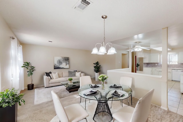 dining area with visible vents, light tile patterned floors, baseboards, light colored carpet, and ceiling fan