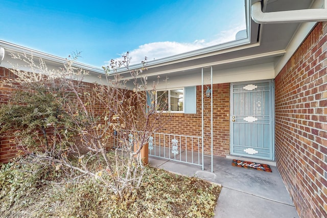 property entrance featuring brick siding