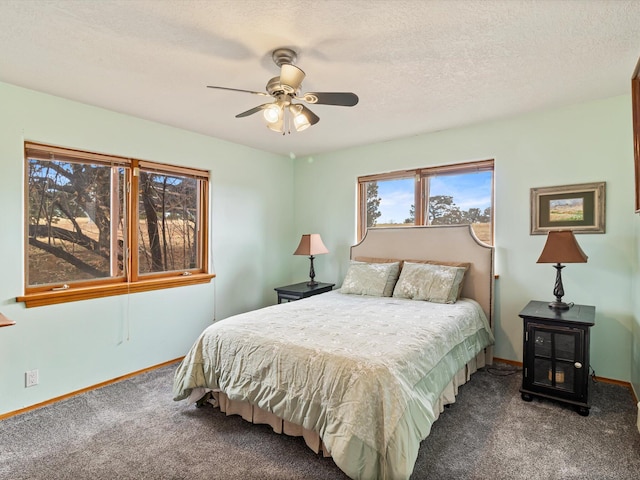 carpeted bedroom featuring baseboards, a textured ceiling, and a ceiling fan