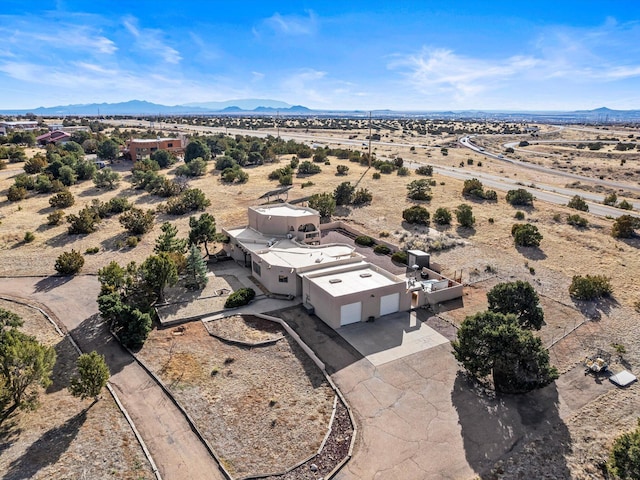 birds eye view of property featuring a mountain view, a desert view, and a rural view