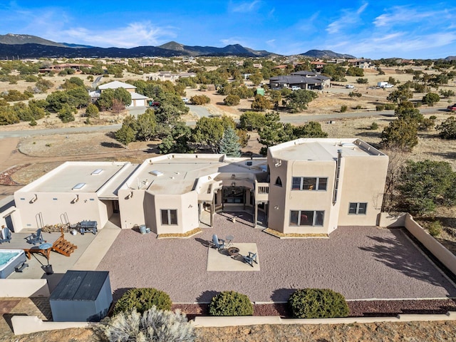 birds eye view of property with a mountain view