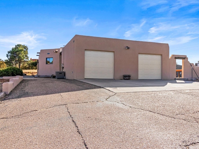 view of home's exterior with a garage and stucco siding