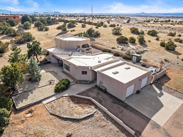 bird's eye view with view of desert and a mountain view