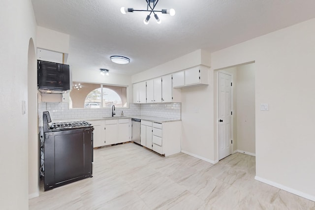 kitchen with a sink, backsplash, gas stove, and stainless steel dishwasher