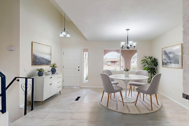 dining area featuring an inviting chandelier, visible vents, baseboards, and high vaulted ceiling