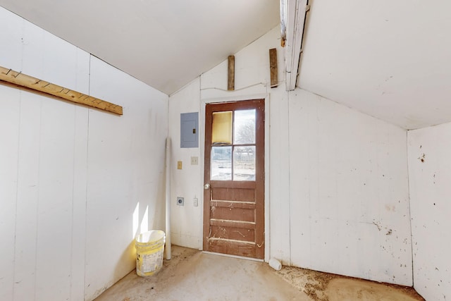 interior space with electric panel and vaulted ceiling