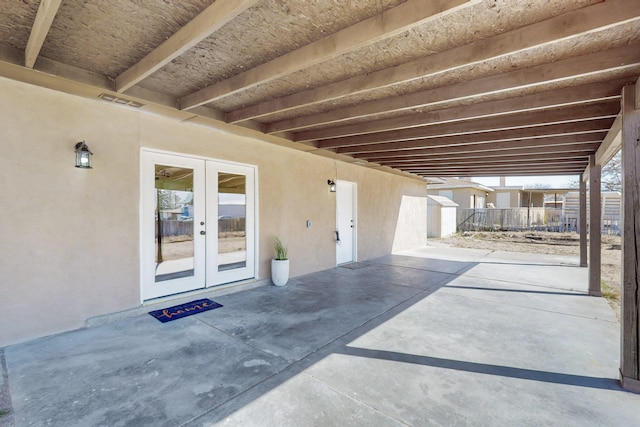 view of patio / terrace featuring visible vents, french doors, and fence