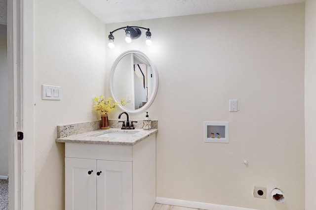 bathroom with vanity and baseboards