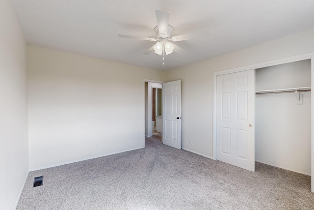 unfurnished bedroom featuring visible vents, baseboards, ceiling fan, carpet floors, and a closet