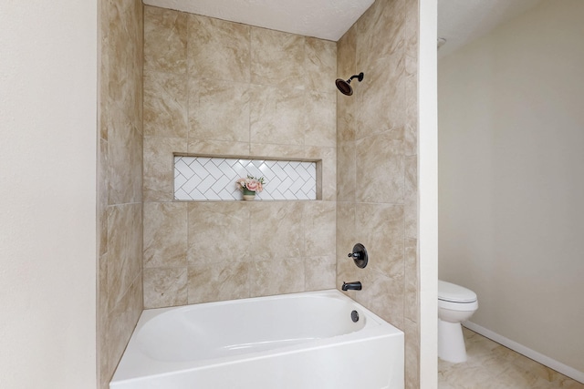 bathroom featuring a bathtub, toilet, a shower, and baseboards