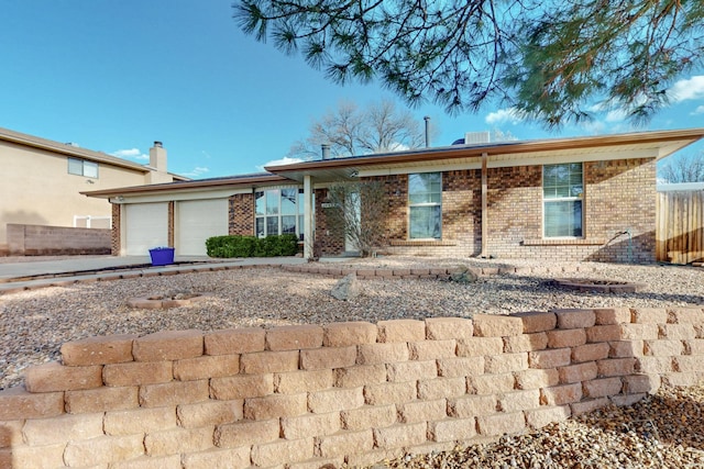 ranch-style home with a garage and brick siding