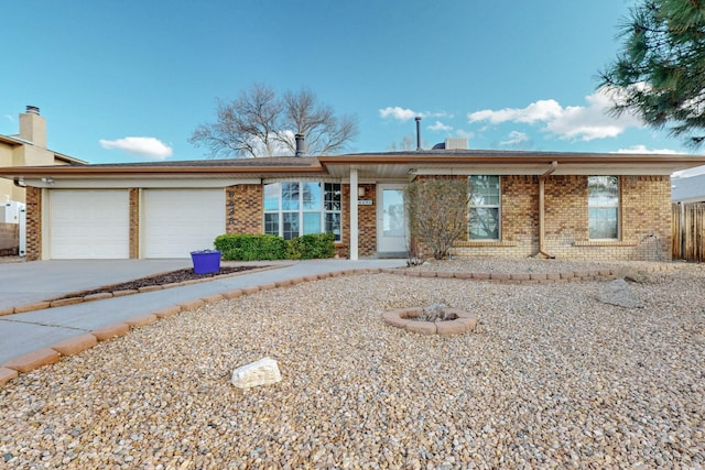 single story home featuring brick siding, driveway, and a garage