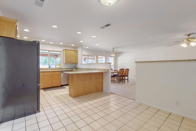 kitchen featuring dishwasher, a ceiling fan, visible vents, and freestanding refrigerator