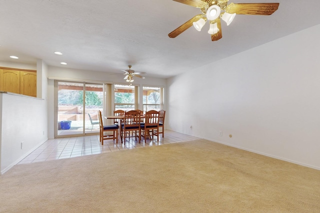 dining area with baseboards, ceiling fan, light colored carpet, light tile patterned floors, and recessed lighting