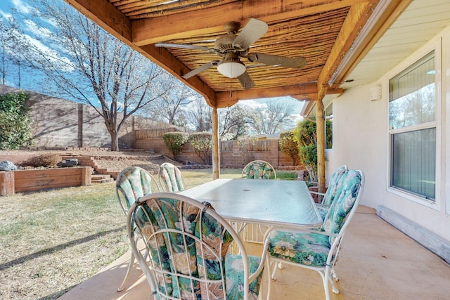 view of patio with outdoor dining area, a ceiling fan, and a fenced backyard