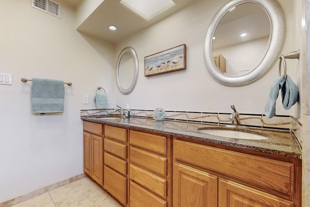 full bath with tile patterned floors, visible vents, double vanity, and a sink