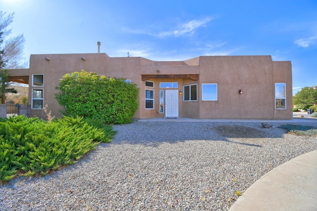 pueblo-style house with stucco siding