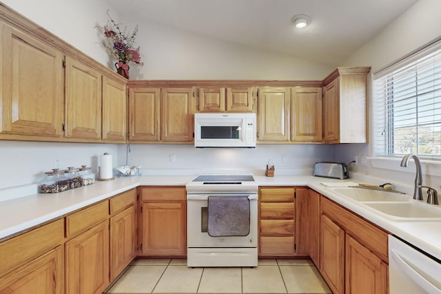 kitchen with white appliances, light tile patterned flooring, a sink, vaulted ceiling, and light countertops