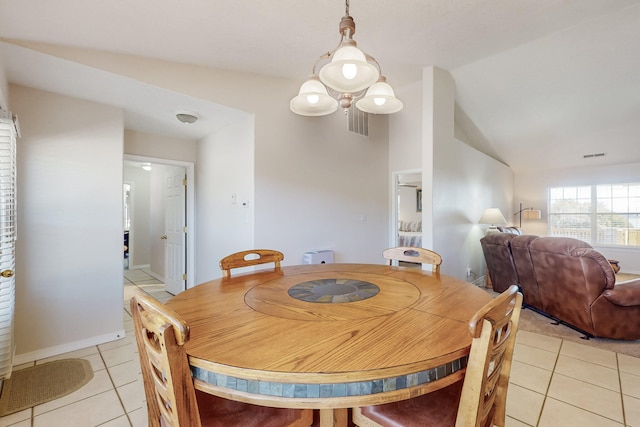 dining area featuring lofted ceiling, light tile patterned flooring, and visible vents