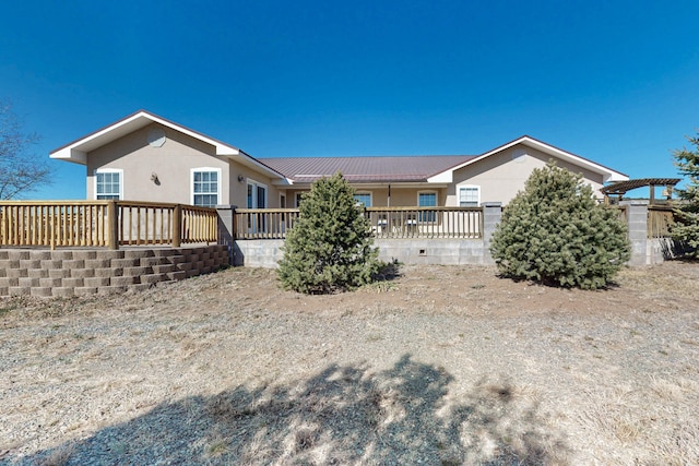 rear view of property featuring metal roof