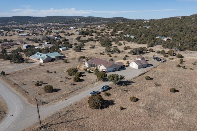 birds eye view of property featuring a mountain view and a desert view