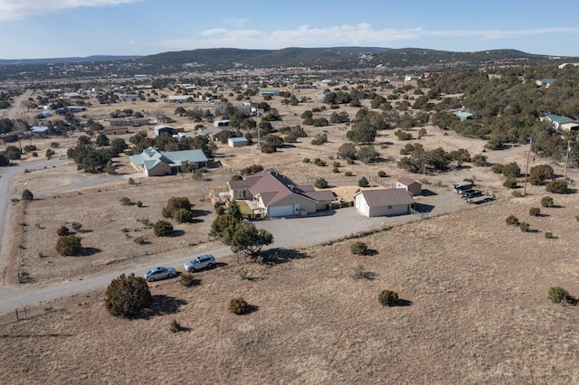 aerial view featuring a desert view and a mountain view