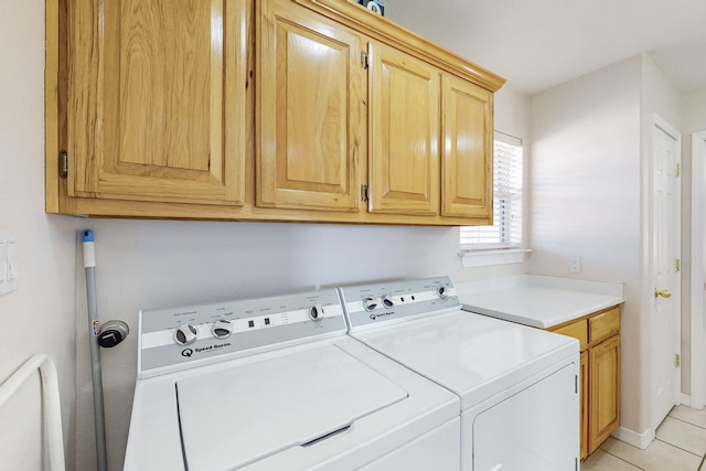 laundry room with cabinet space, washing machine and dryer, and light tile patterned flooring