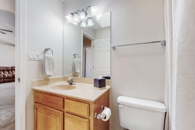 bathroom featuring toilet, ceiling fan, and vanity