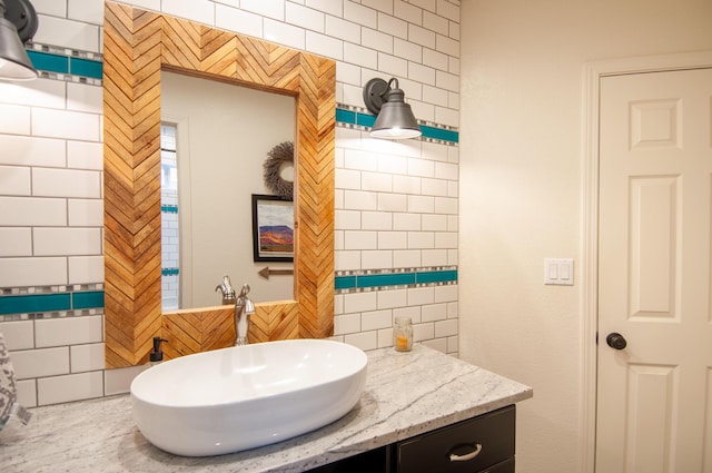 bathroom with tasteful backsplash, vanity, and tile walls