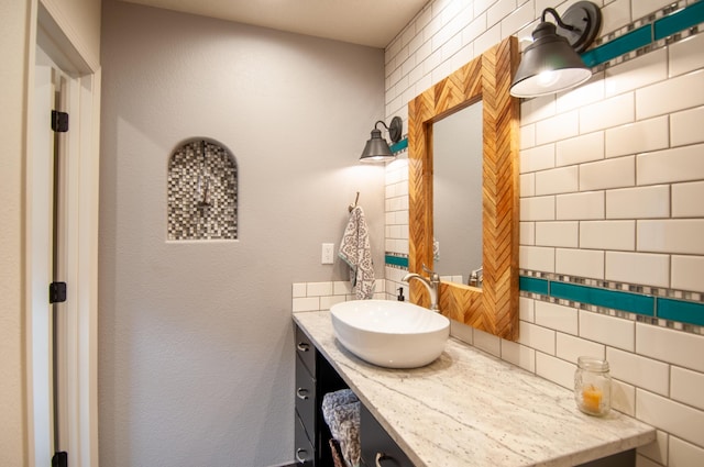 bathroom featuring decorative backsplash and vanity