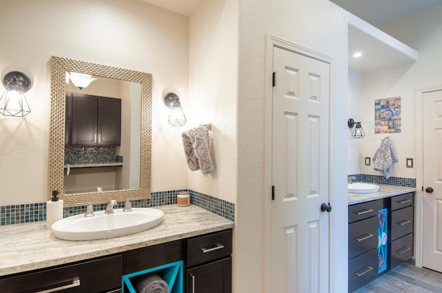 bathroom featuring vanity and backsplash