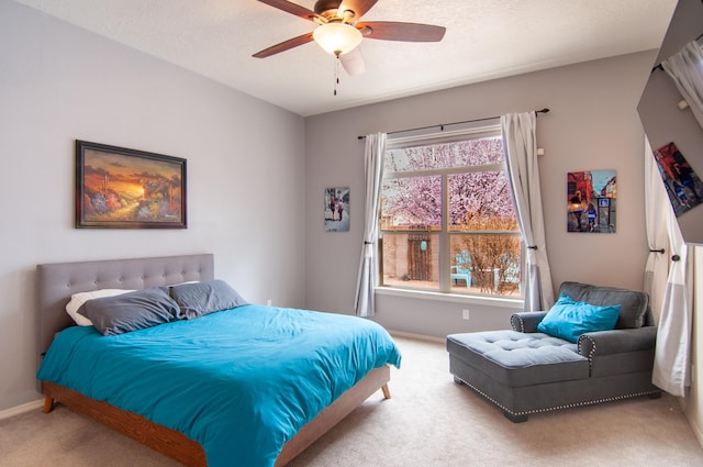 bedroom featuring a textured ceiling, ceiling fan, and carpet flooring