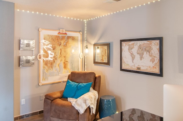 living area featuring baseboards and wood finished floors