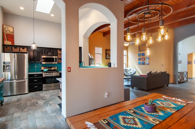 interior space with beamed ceiling, dark wood-style floors, wood ceiling, and arched walkways