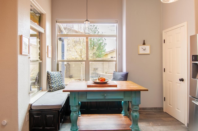 dining room featuring wood finished floors, baseboards, and breakfast area